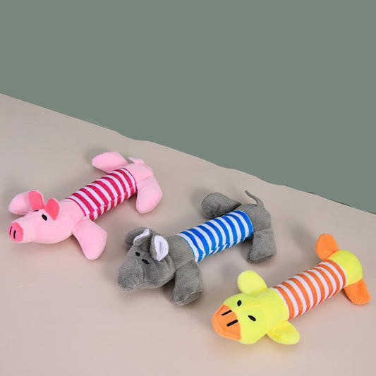 Three colorful plush toys shaped like animals on a beige surface with a green background.