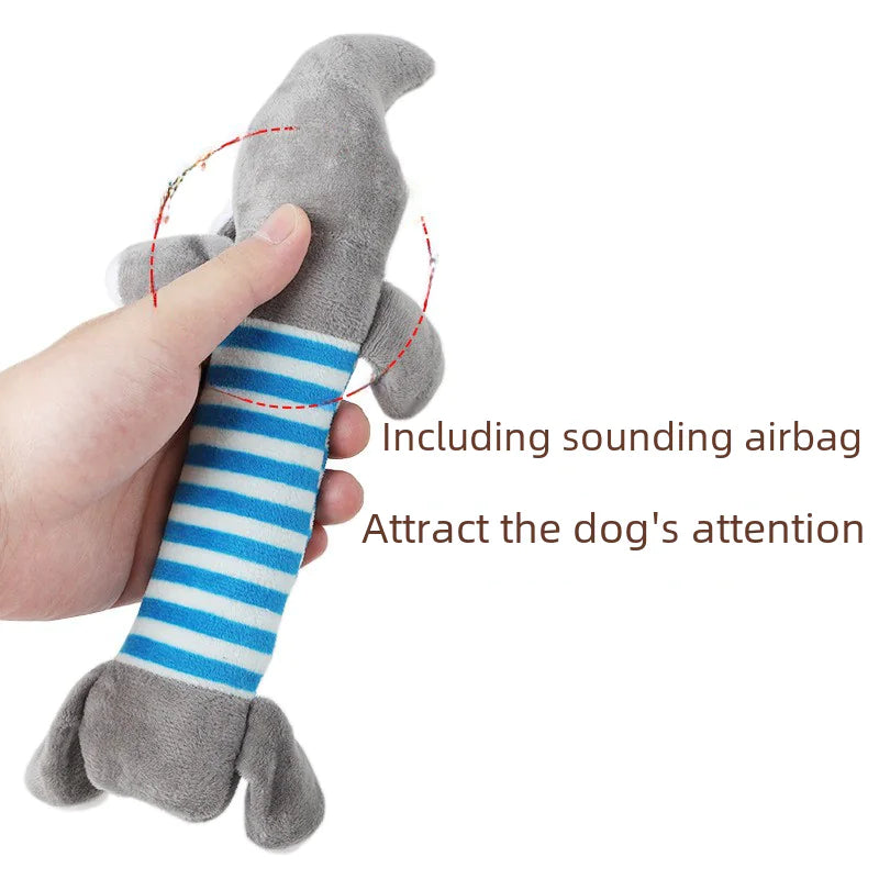 Dog toy with a sounding airbag held by a hand on a white background